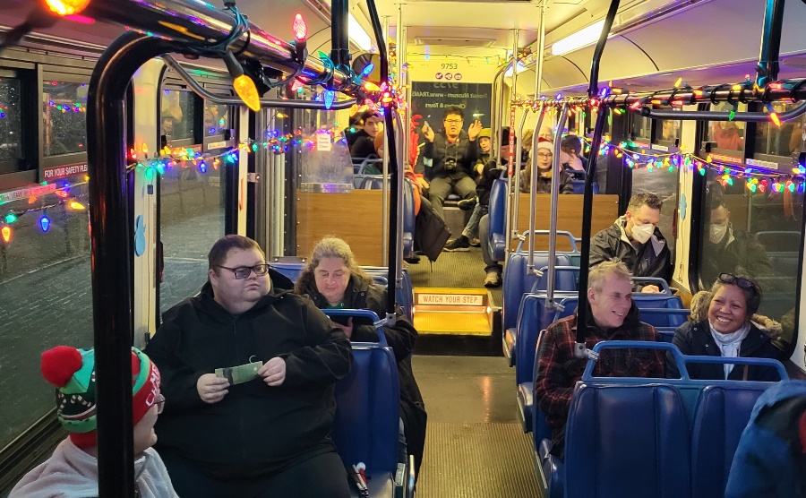 A group of people ride on a bus

Description automatically generated with medium confidence
