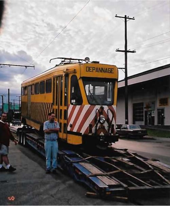 A person standing next to a train Description automatically generated with medium confidence