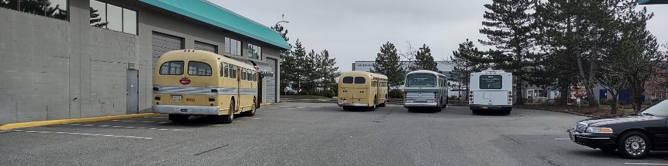 A group of buses parked outside a building

Description automatically generated with low confidence