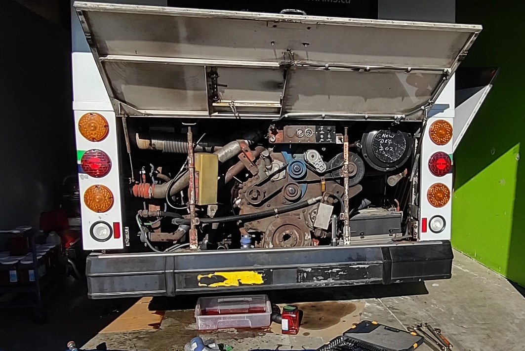 The back of a truck with the engine open

Description automatically generated